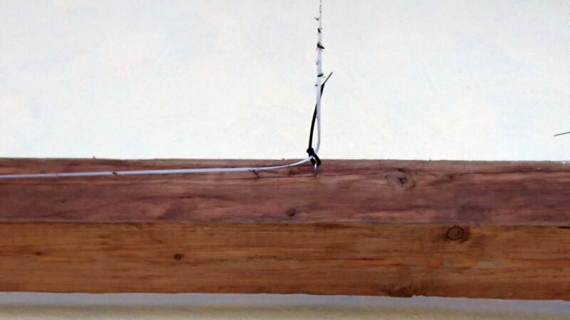 Wires attached to a wooden beam